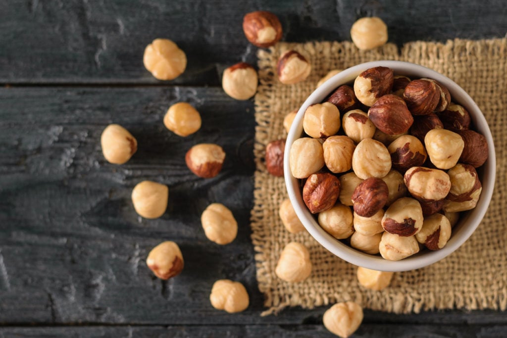 A bowl of hazelnuts on a table