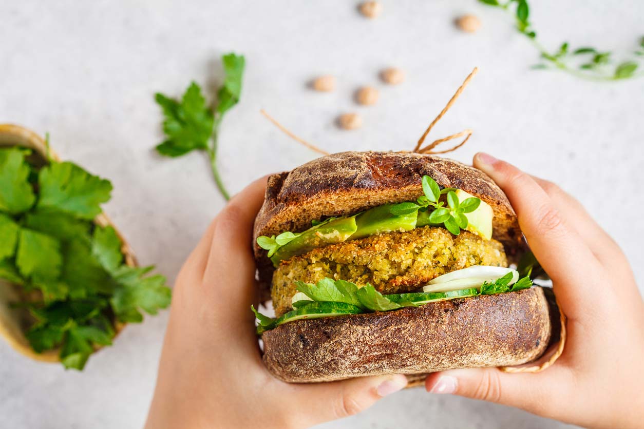 hands holding veggie burger