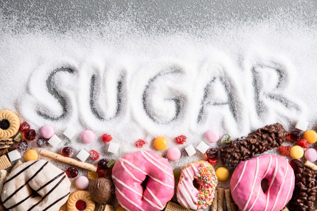 Sugar spelled out in sugar with a variety of sweet treats