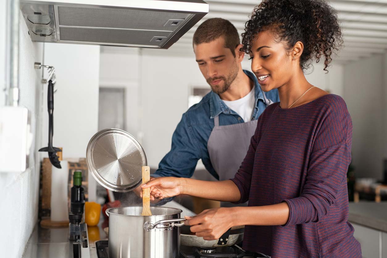 Couple cooking pasta together