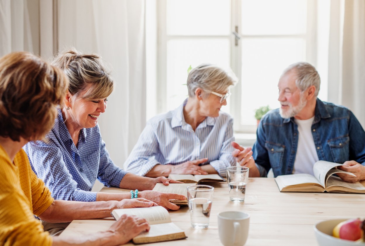 Senior people in bible reading group in community center club.