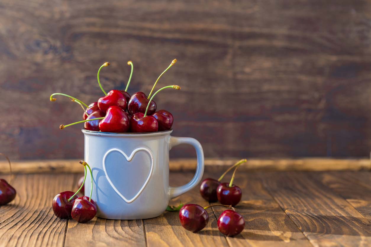 cherries in a mug with a heart on it