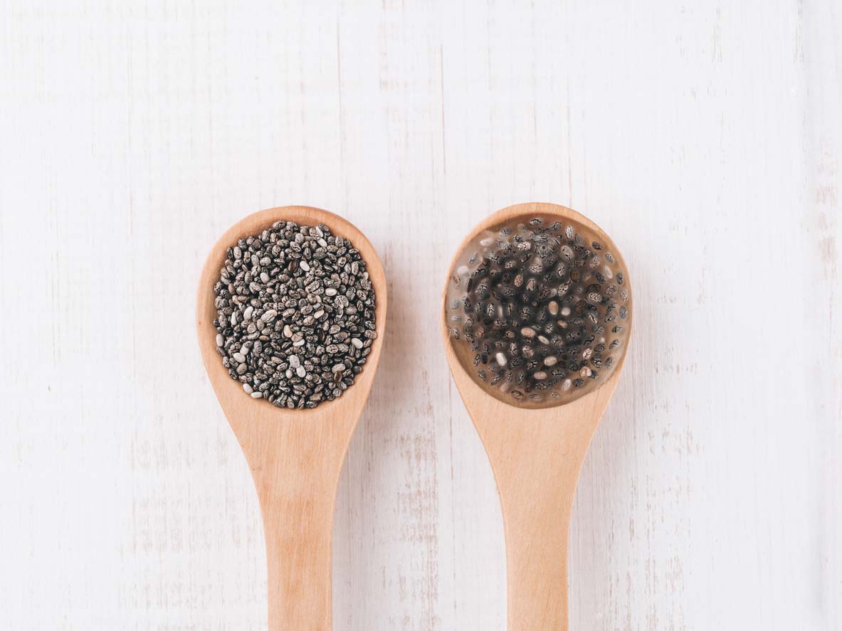 Raw chia seeds in wooden spoon; Chia egg in wooden spoon