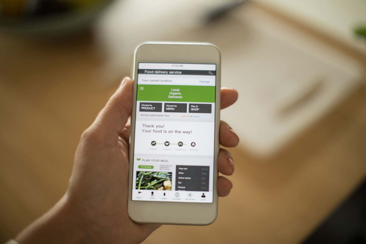 woman using plant-based meal delivery service on mobile app