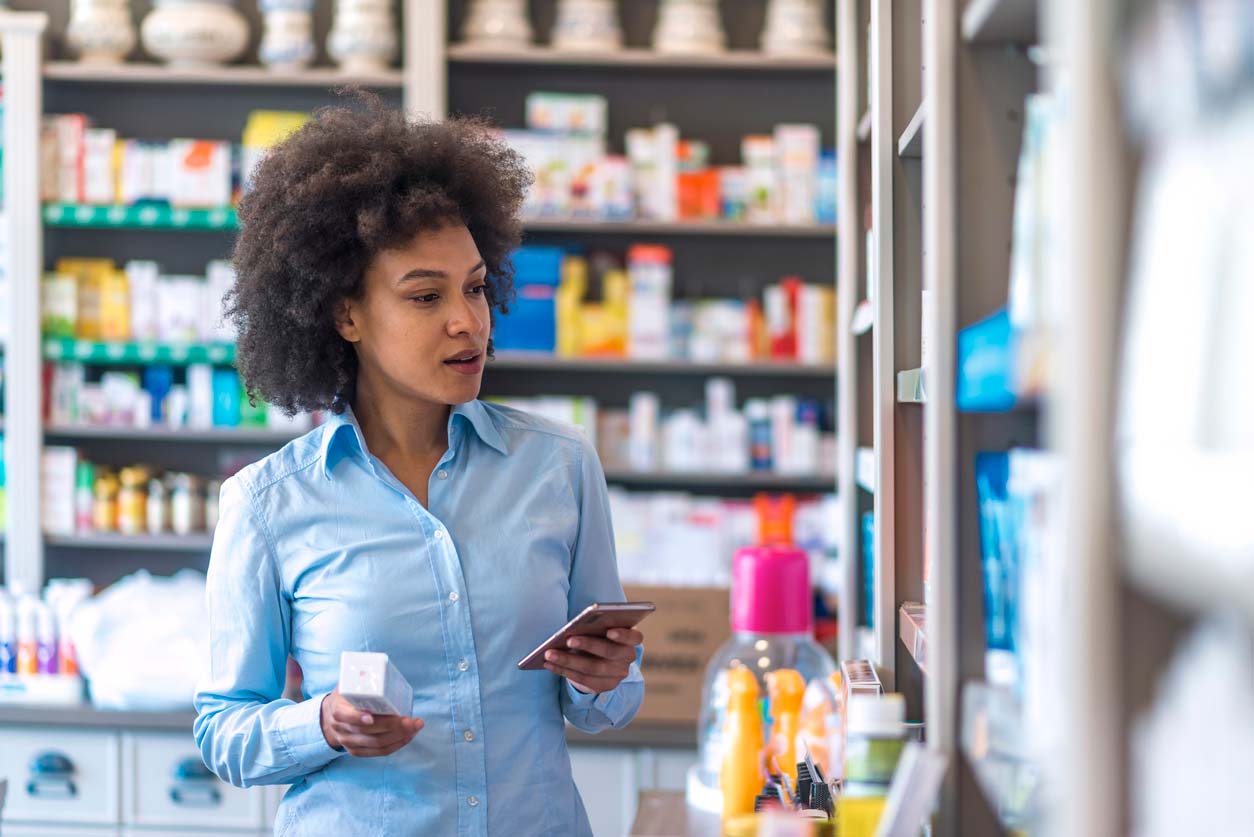 Woman looking at skincare products in pharmacy