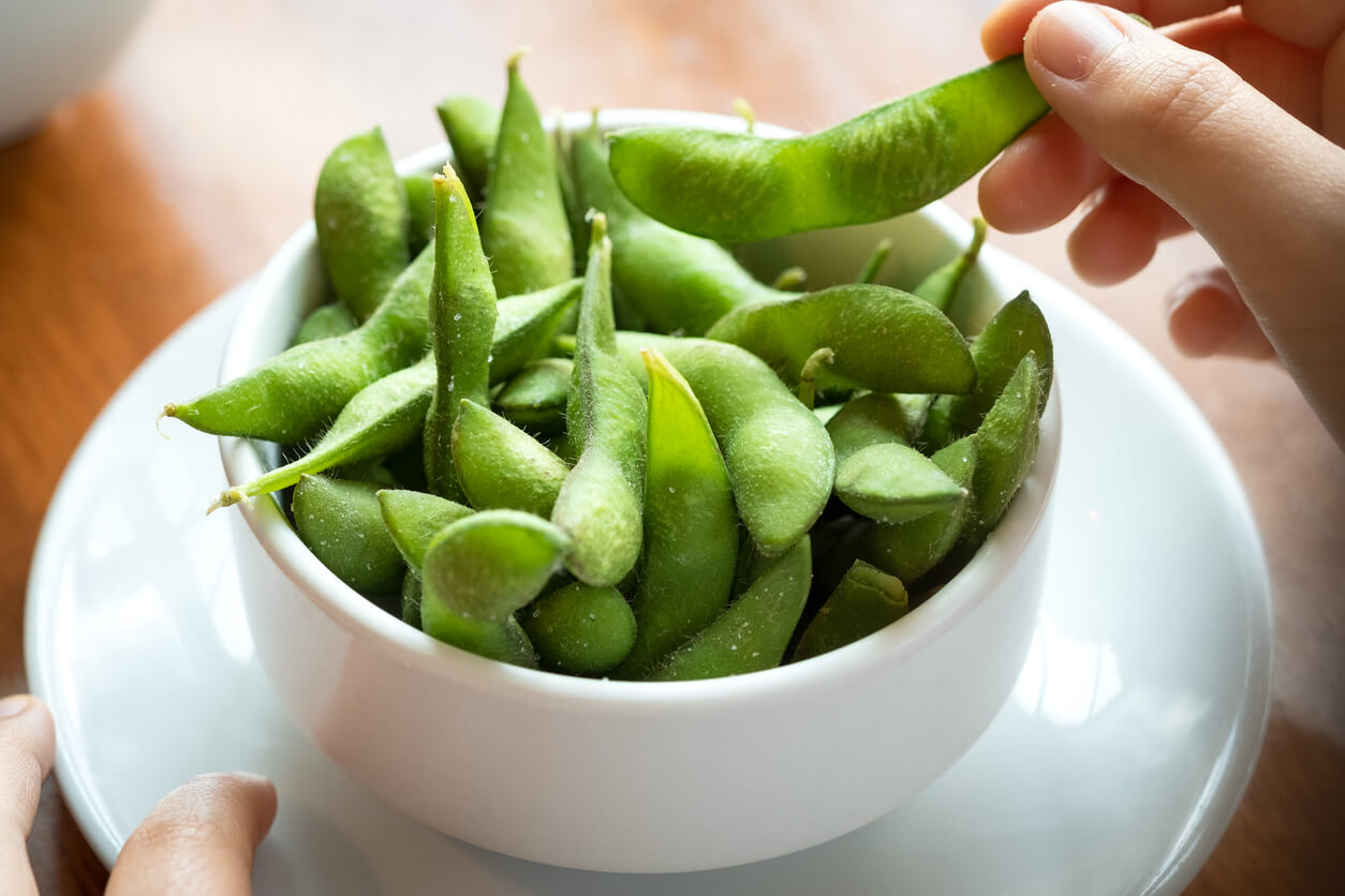 pop salted edamame beans eating Japanese food by hand