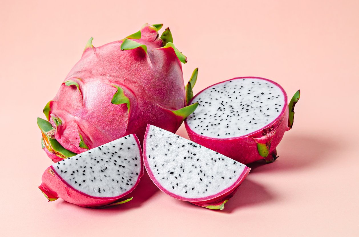 Fresh dragon fruit on pink background.