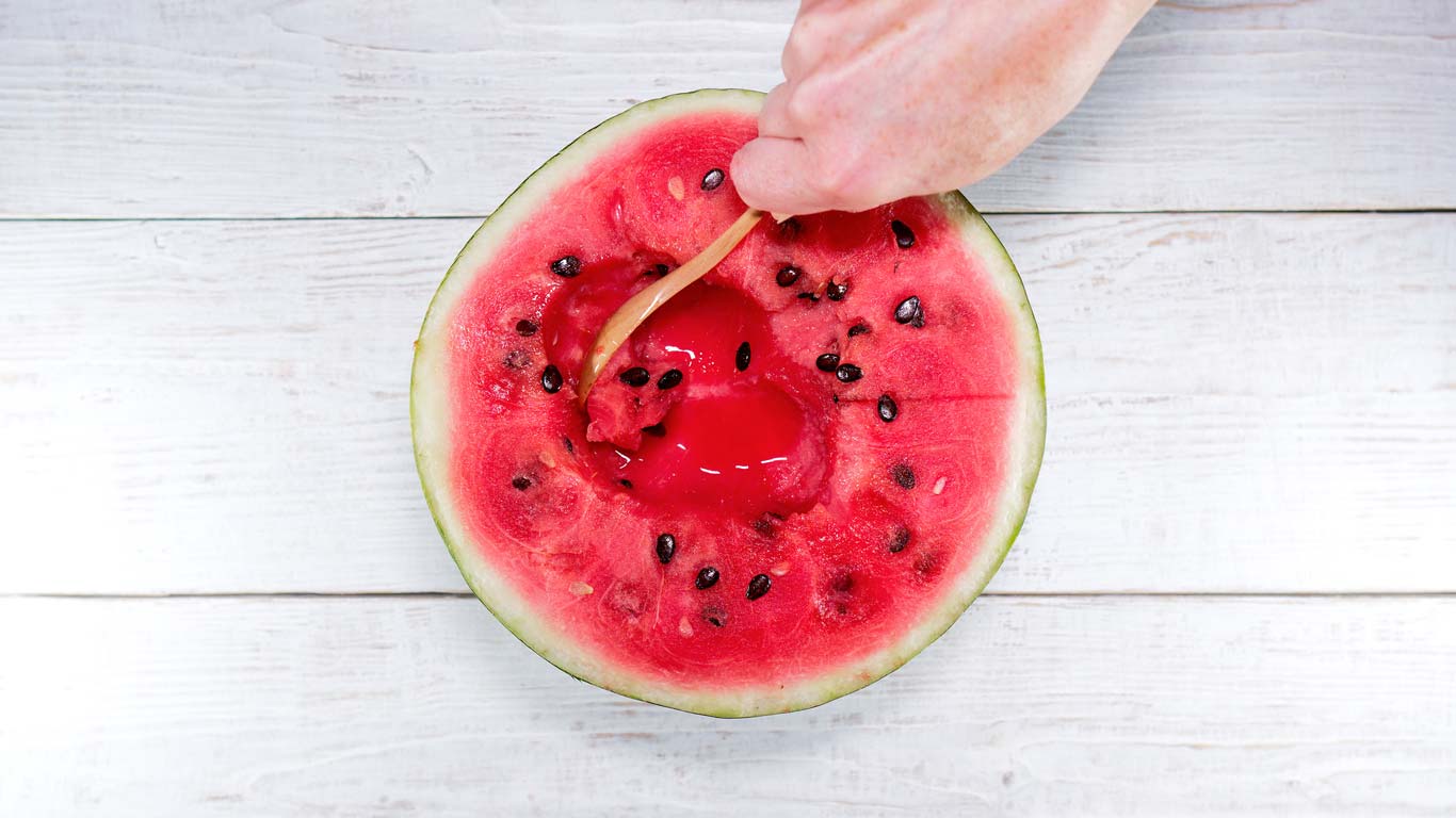 scooping watermelon from rind