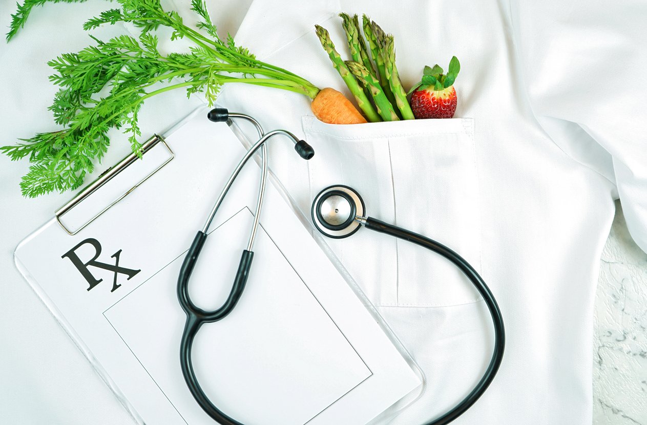 healthy lifestyle concept with doctors lab coat and healthy food