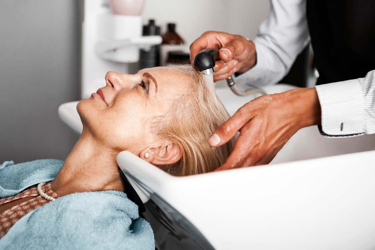 woman getting hair washed at salon