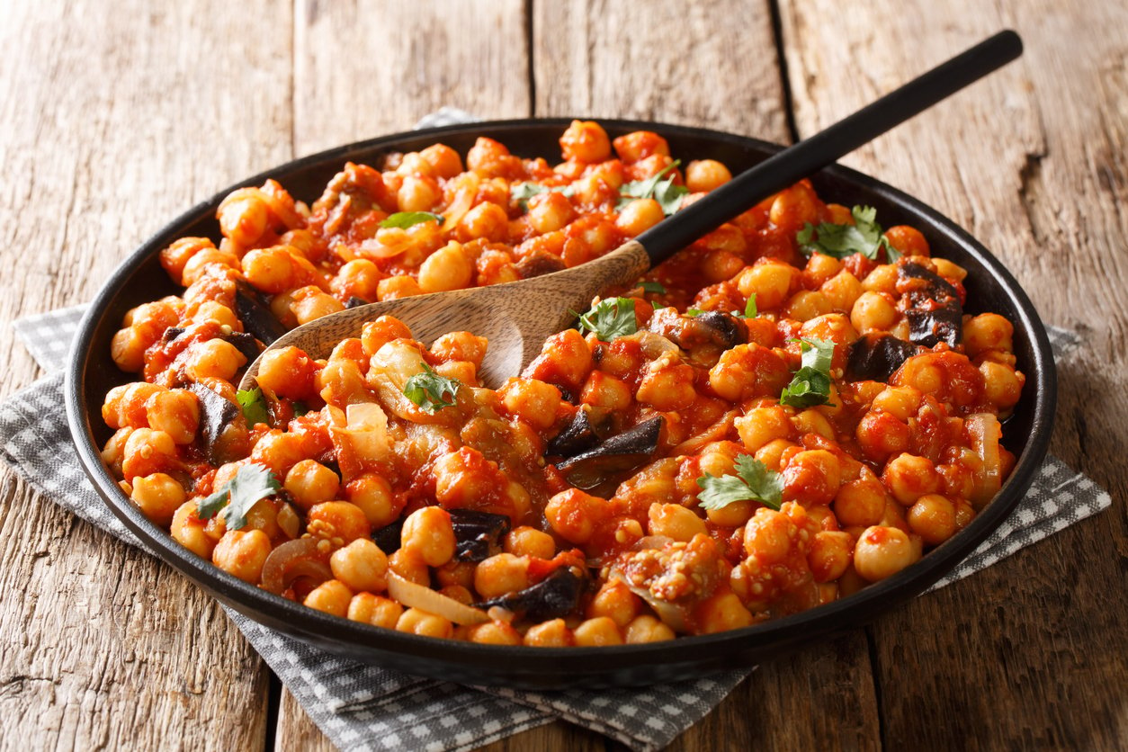 mnazaleh chickpeas with eggplant in tomato sauce close-up on a plate on the table. horizontal