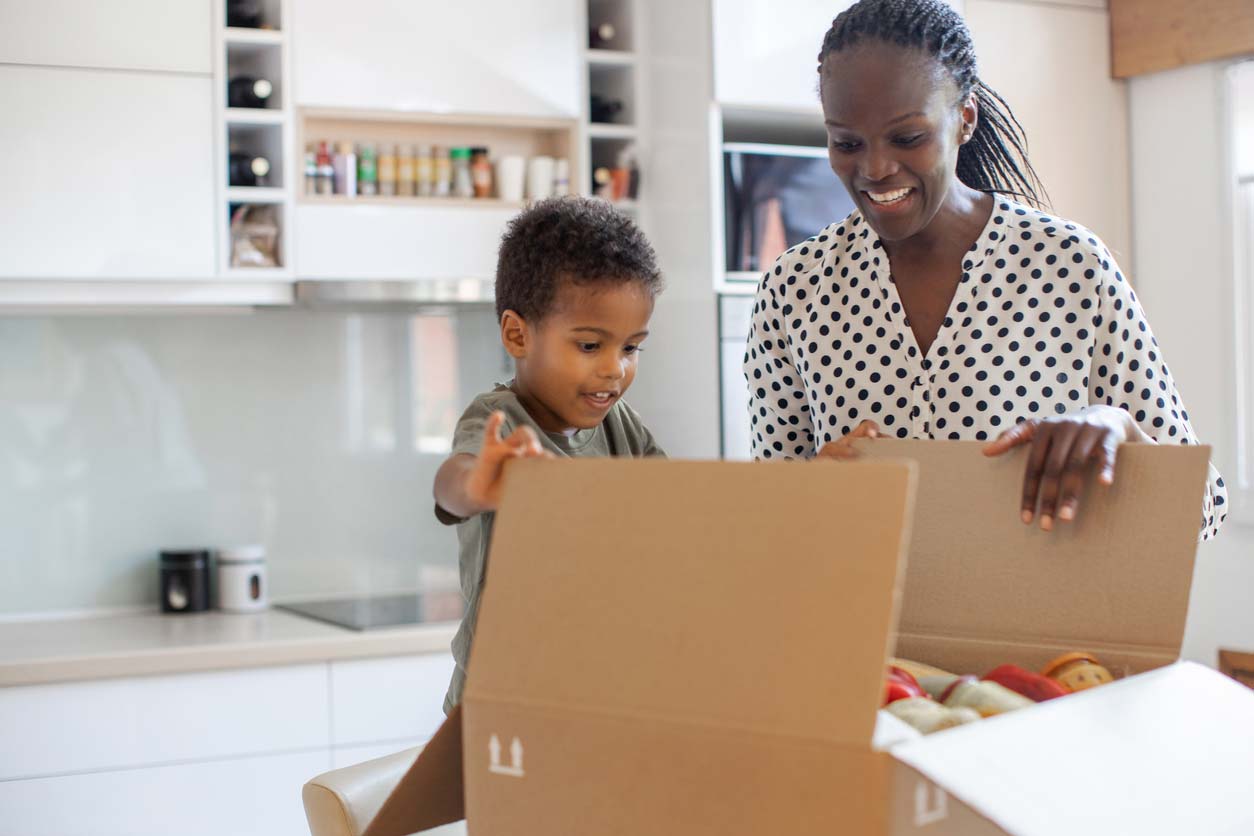 mother and child opening meal subscription box