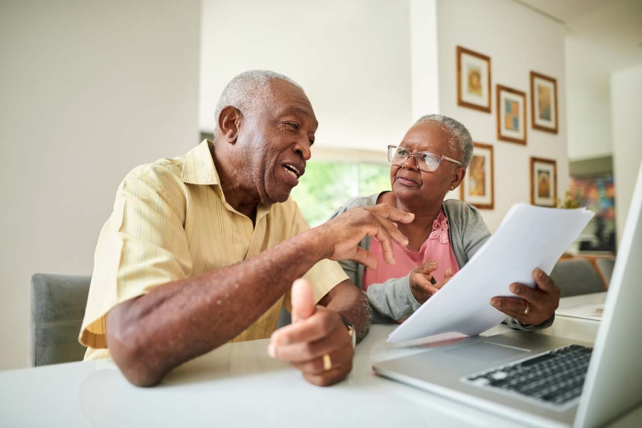 Older couple talking over paperwork