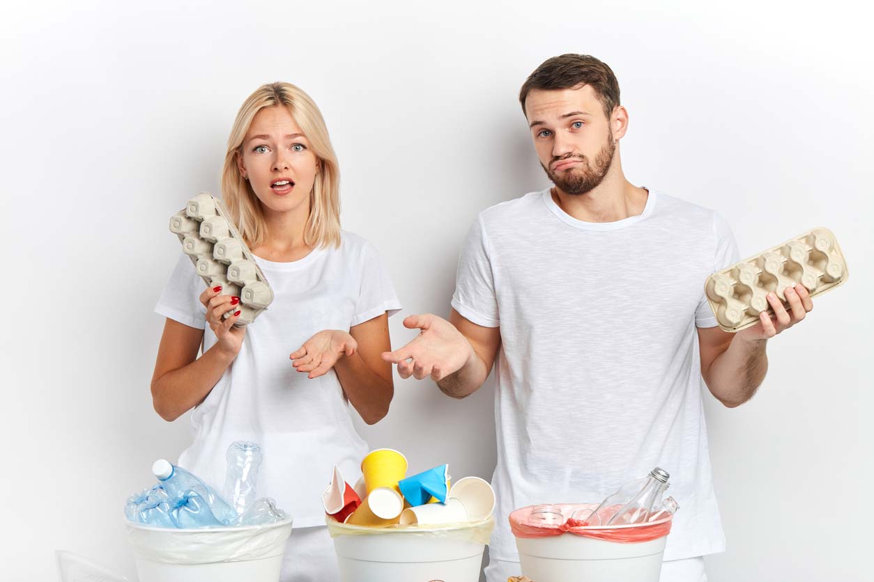 puzzled man and woman hesitating how to reuse carton of eggs