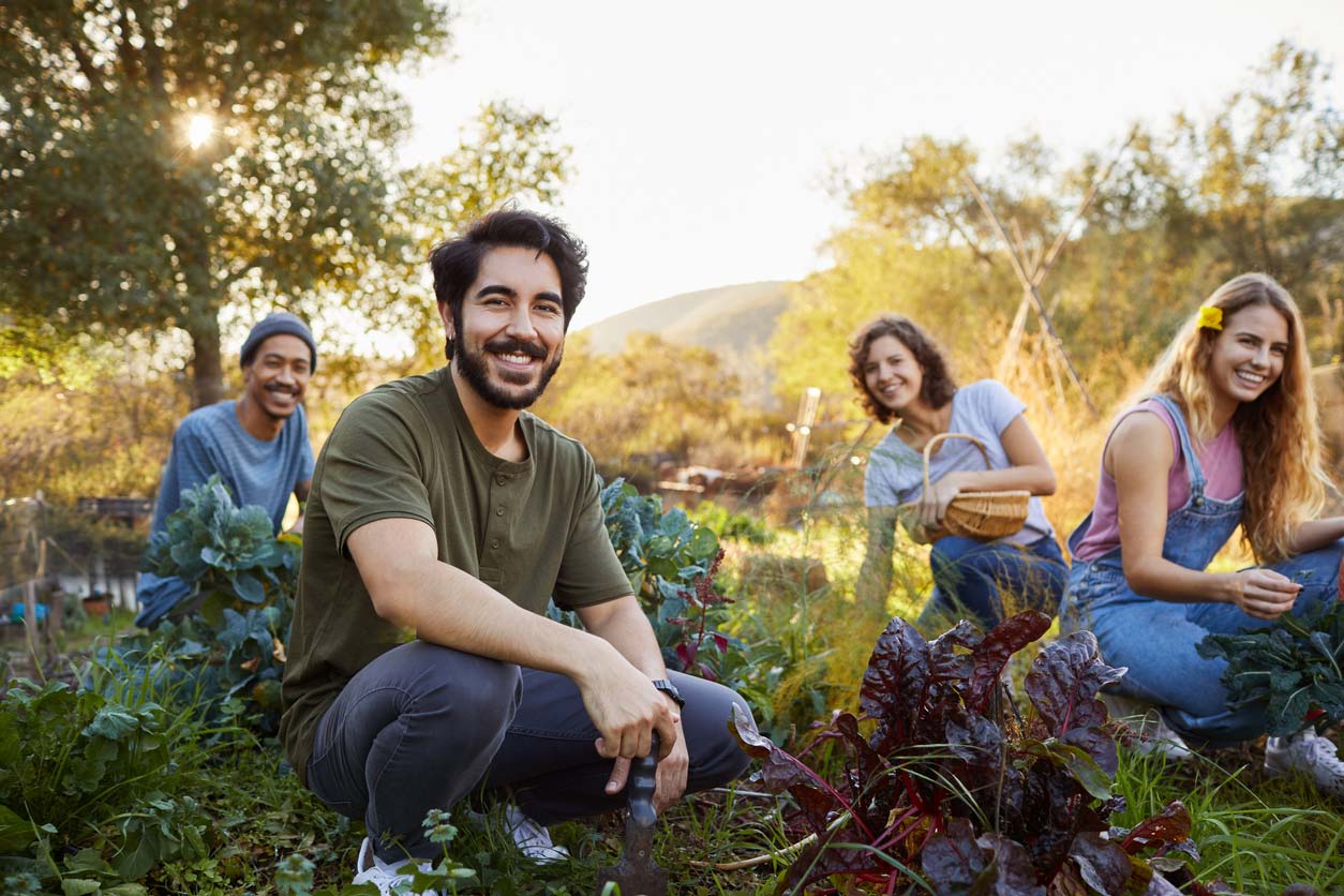 group of young friends working in community garden