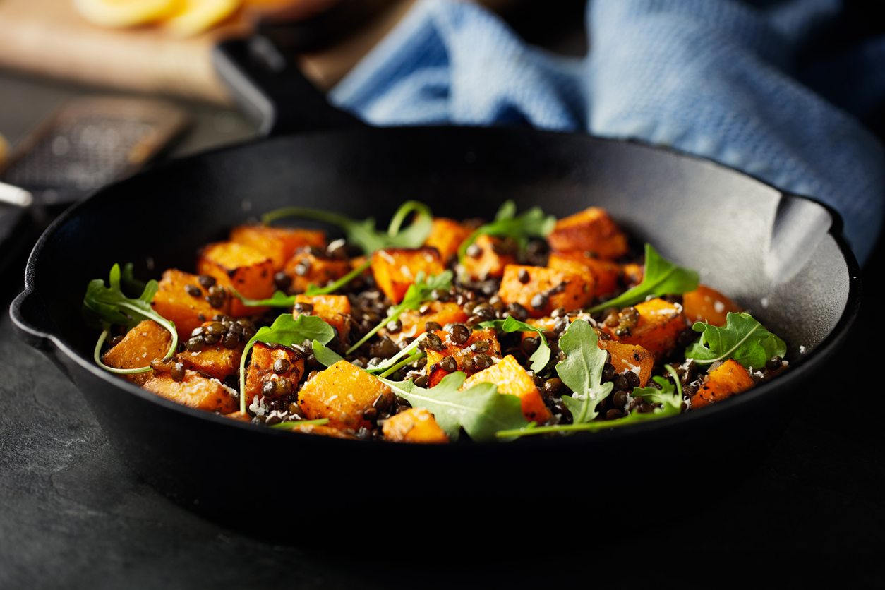roasted butternut squash with green lentils and rocket leaves