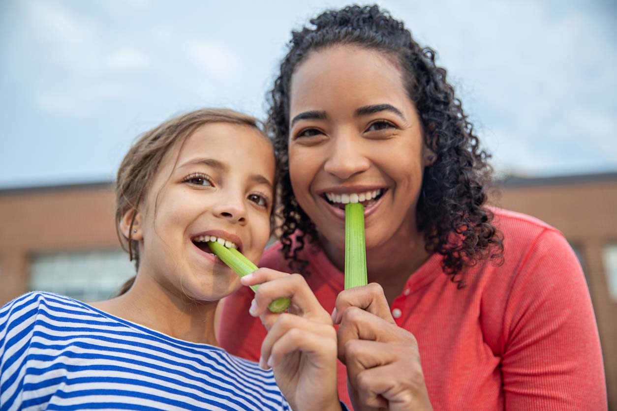 woman and child eating celery
