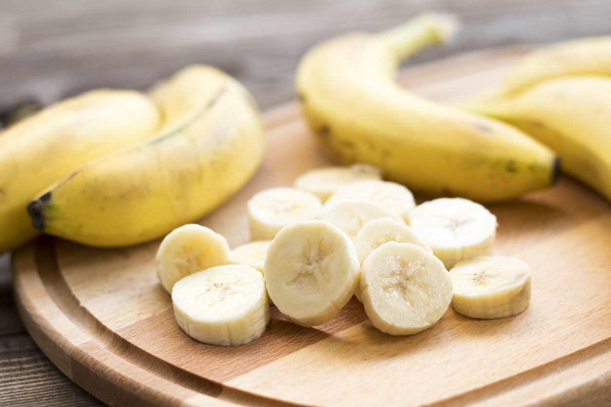 Fresh bananas on wooden background.