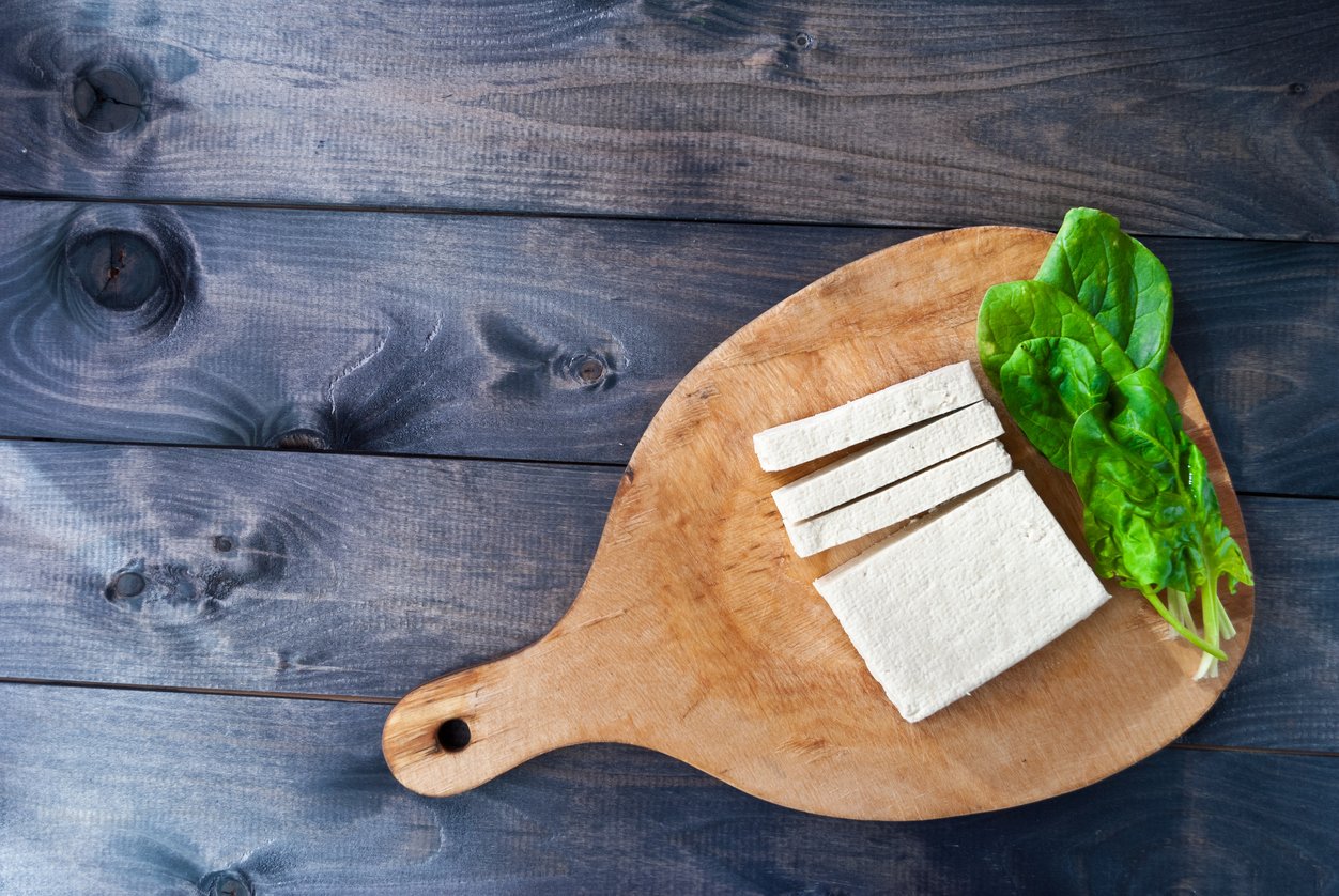 Slices of raw tofu and spinach