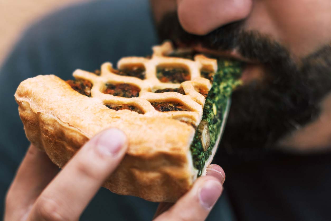 Healthy pie recipes - Man eating savory pie slice
