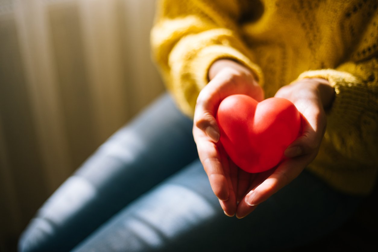 Woman holding red heart