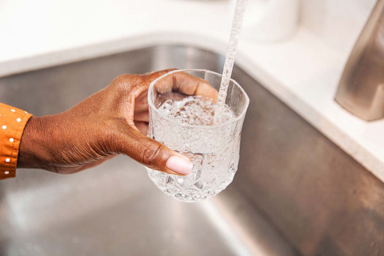 filling glass with water from the tap