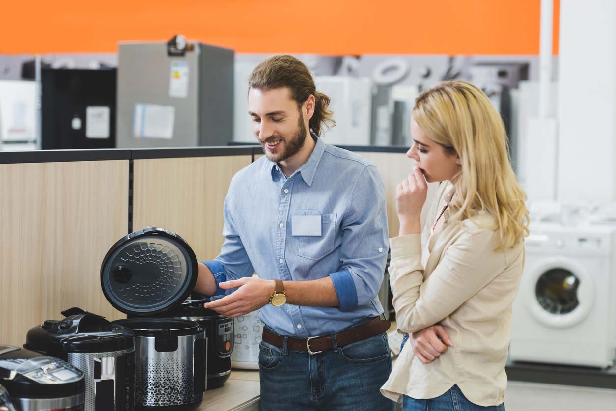 sales rep talking over slow cookers with customer