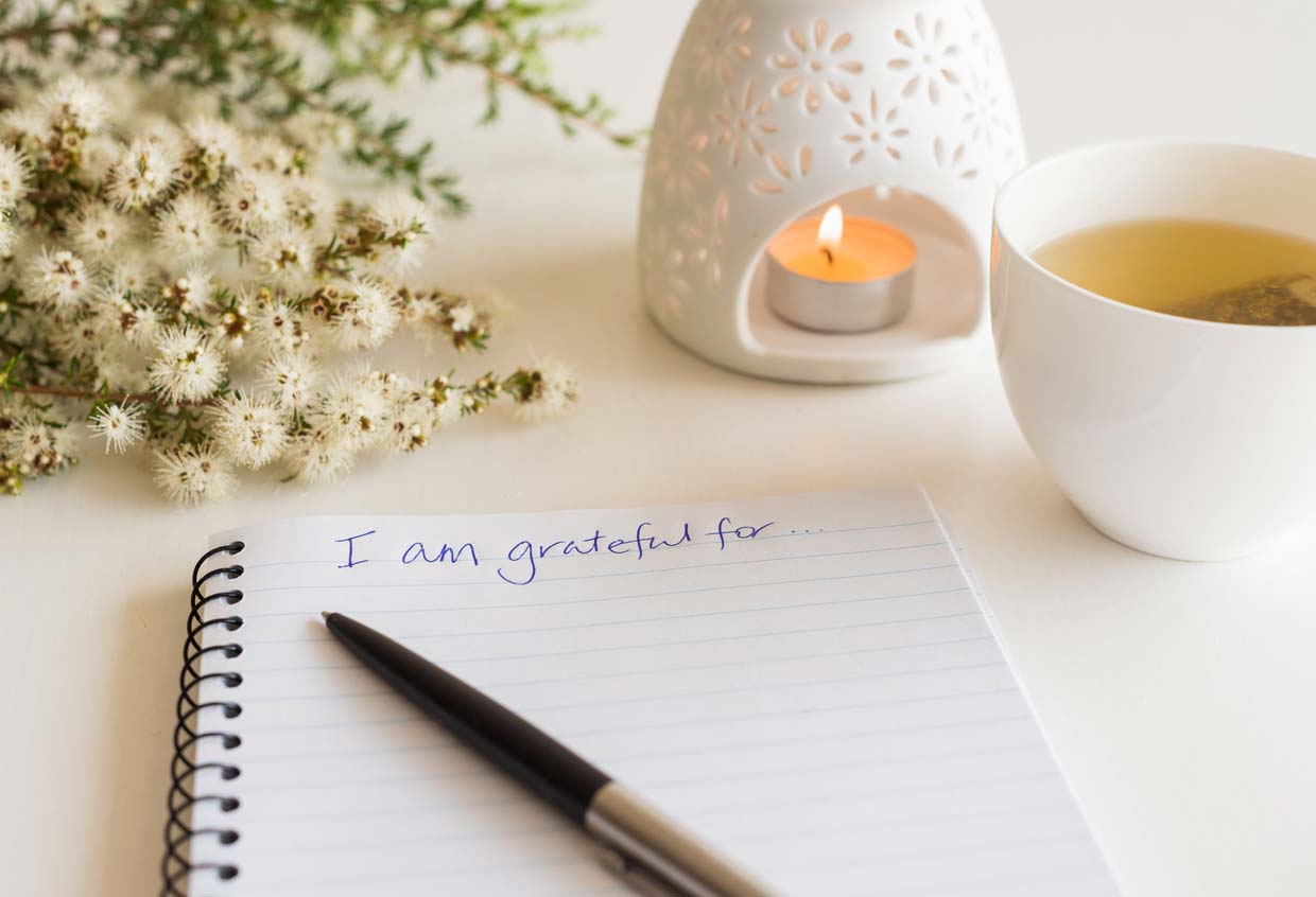 practicing gratitude in a notebook