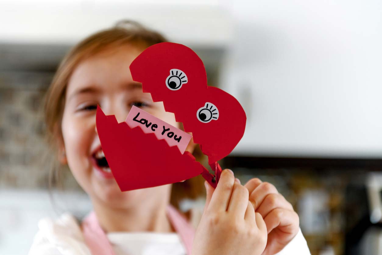 young girl with heart clip that says love you