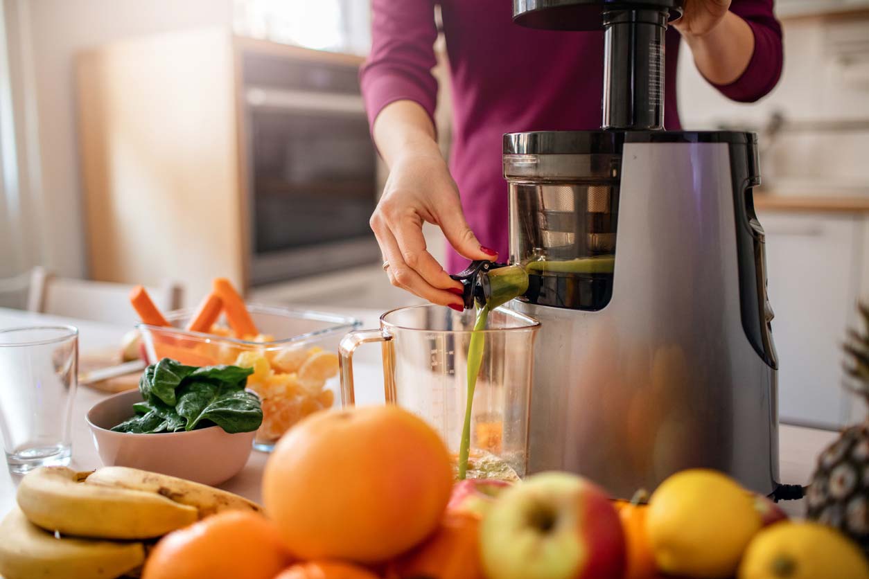 Auger juicer being used to make fresh green juice