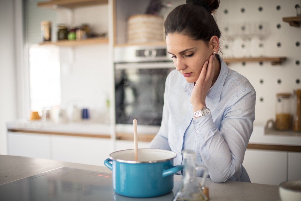 Come on, it's lunch time. Woman cooking in kitchen.