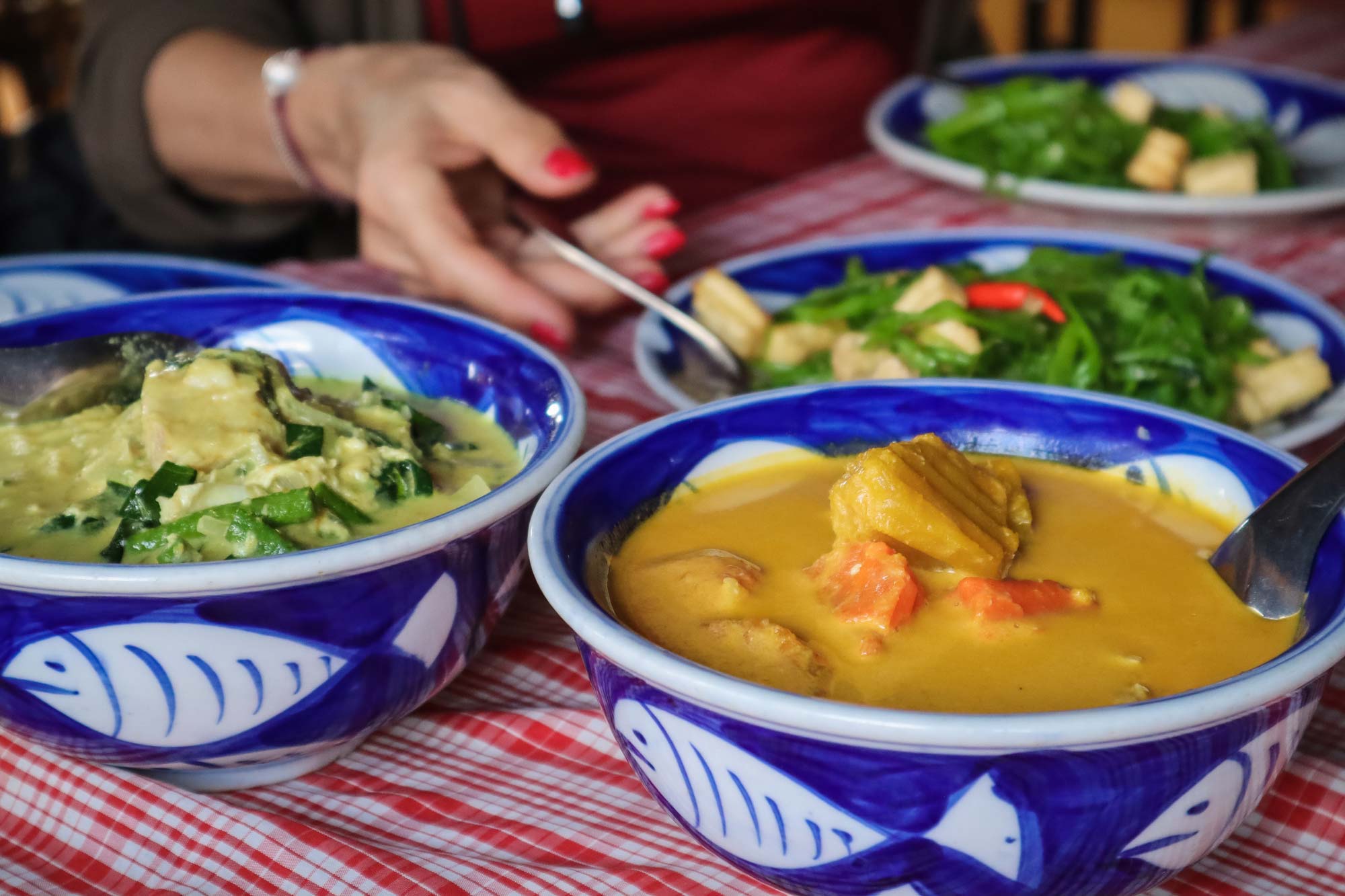 various bowls of curry on table