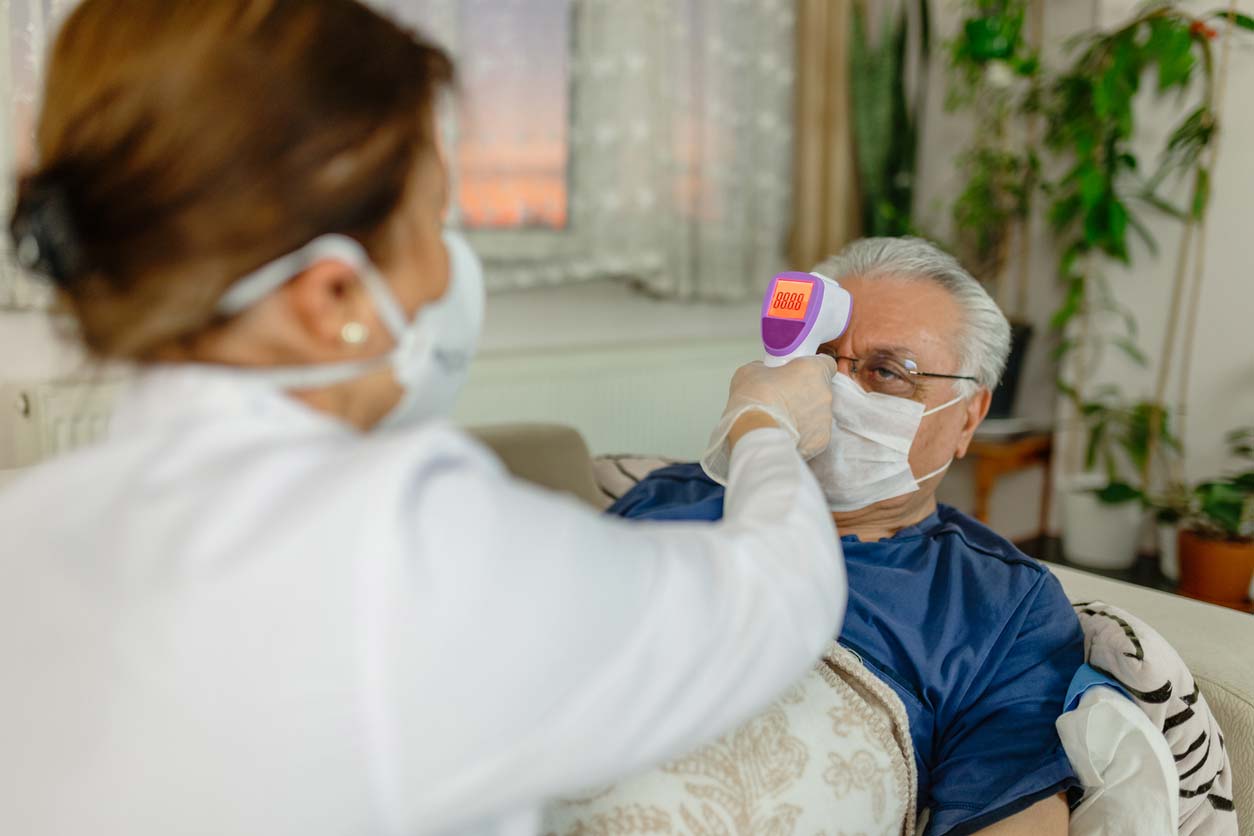 man having temperature taken at home