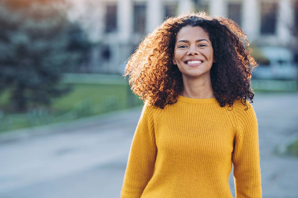 woman in yellow shirt smiling