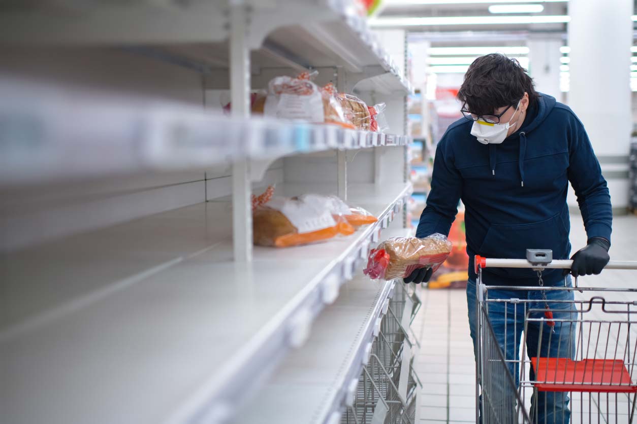 man in ppe grocery shopping