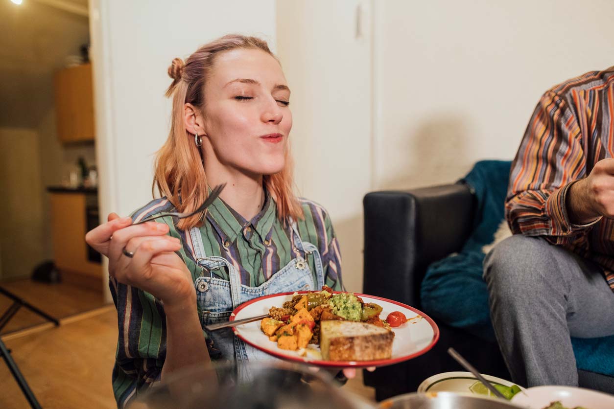 Woman enjoying a plate of food