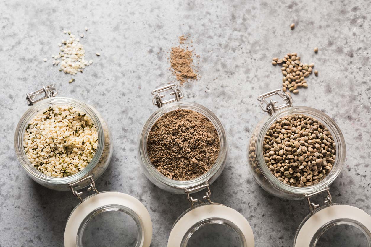 Hemp seeds, hearts, and powder in jars