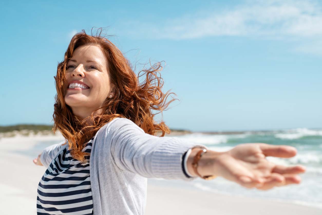 woman enjoying breeze at the beach