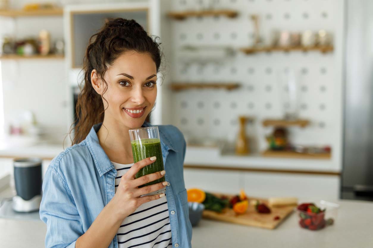 woman enjoying green smoothie