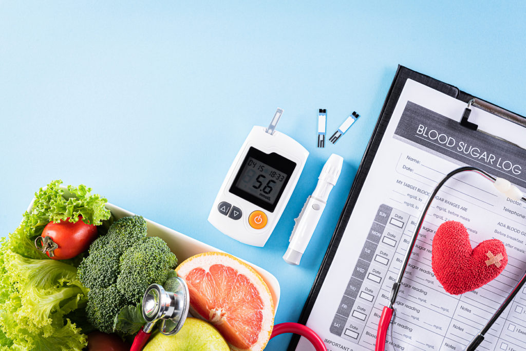 Blood sugar log with glucose monitor and diabetes-friendly foods