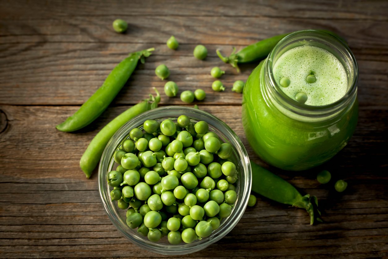 ripe green peas on a wooden table