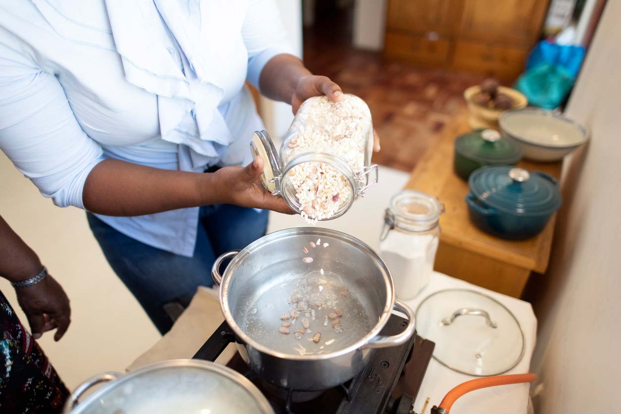 Pouring rice and beans into boiling water