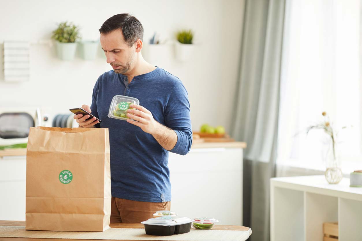 man unpacking meal delivery service bag