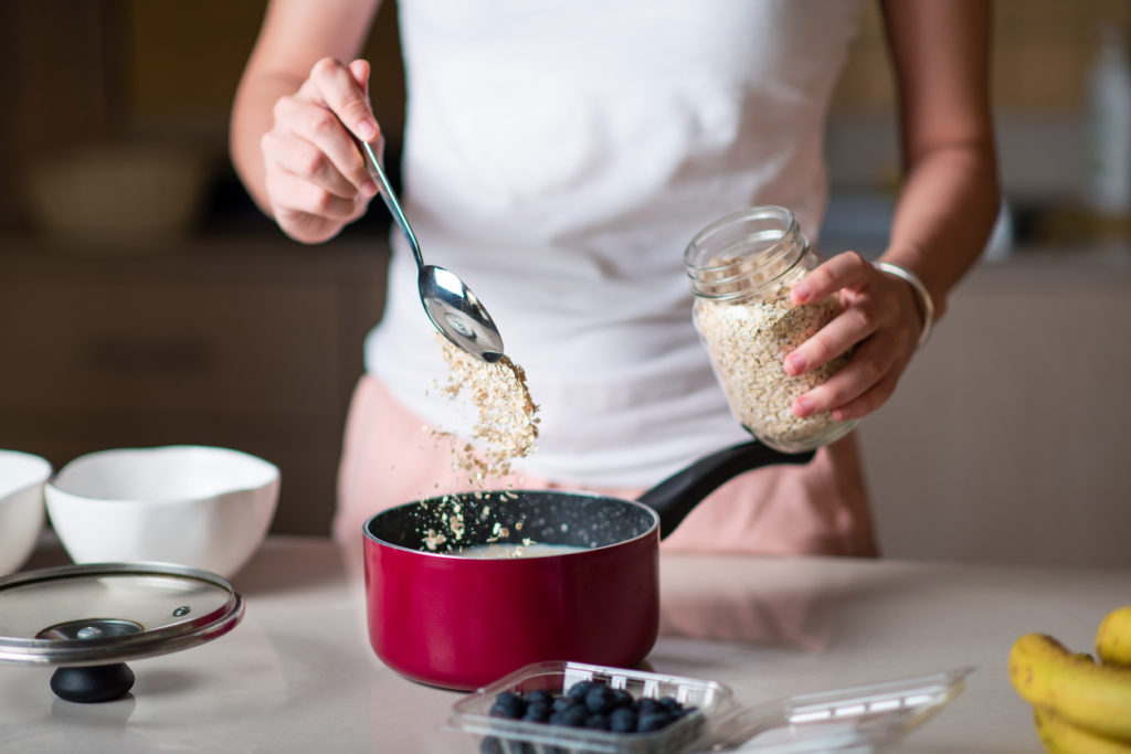 cooking with whole grain oats in a sauce pan