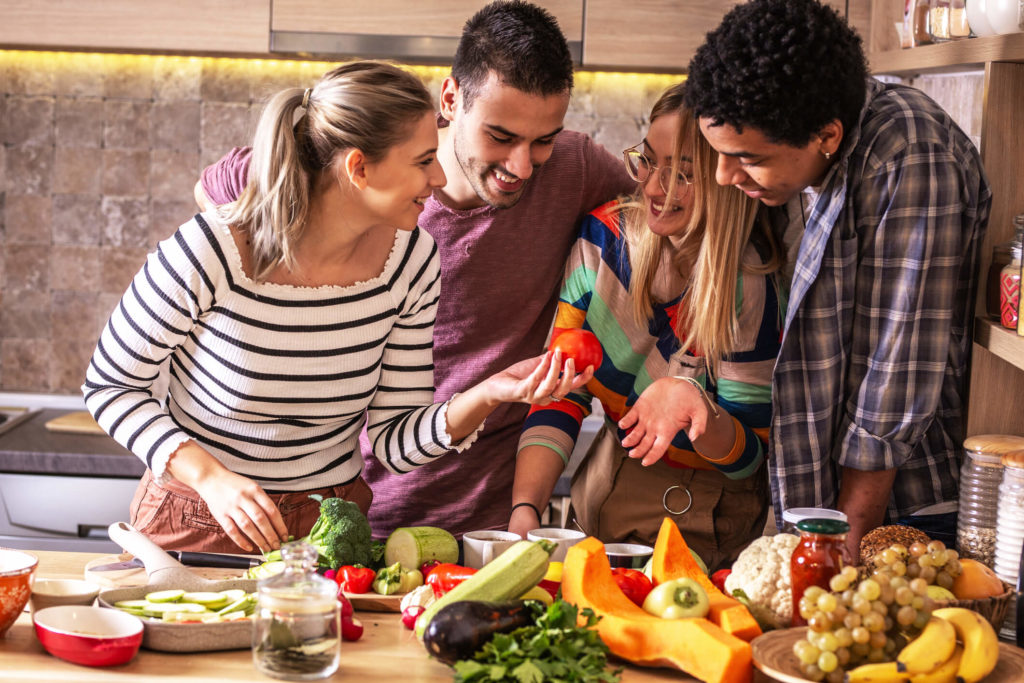 Young adults in the kitchen discussing healthy food