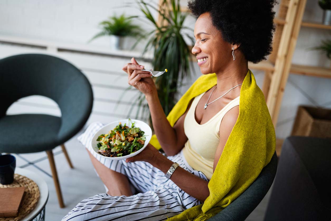 woman of color eating a healthy salad