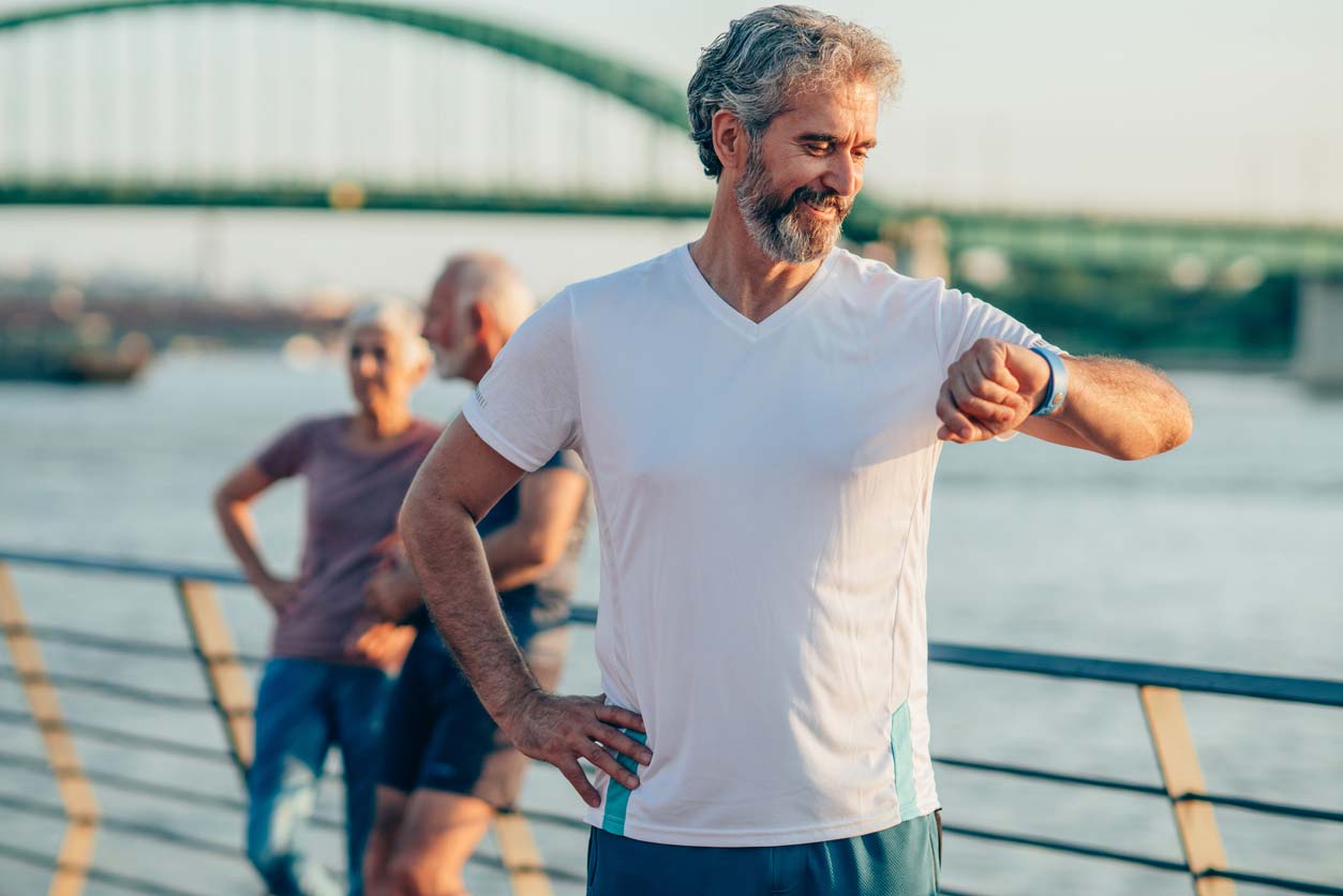 male athlete checking health tracker on wrist