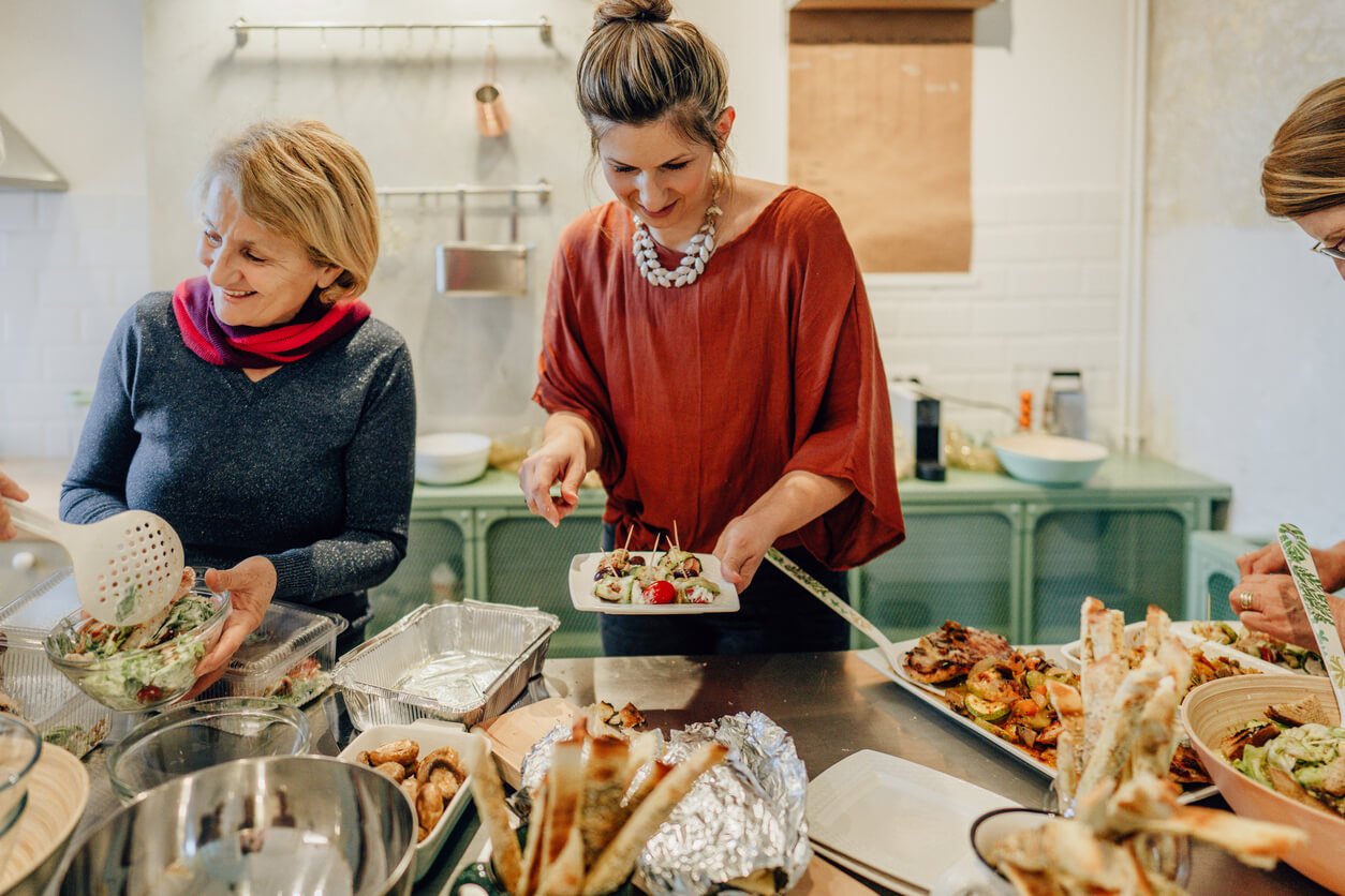 mother and daughter preparing thanksgiving dinner in the kitchen