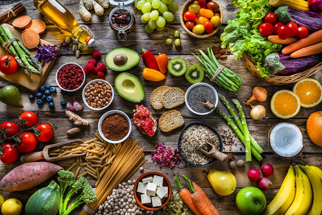 Vegan food backgrounds: large group of fruits, vegetables, cereals and spices shot from above