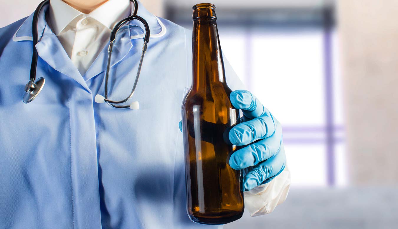 doctor in uniform holding beer bottle